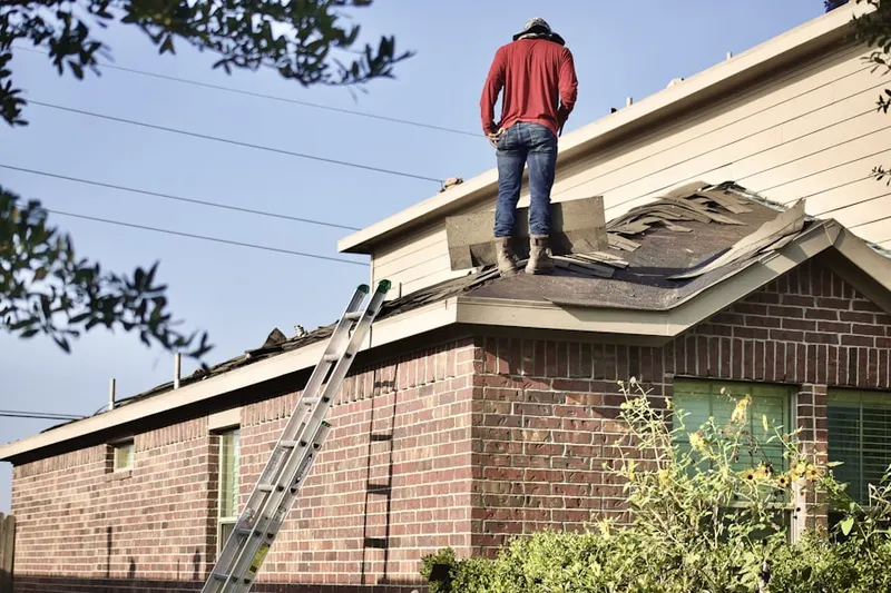 Professional roofer working on a residential roof in Hunters Trace
